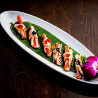U5. Akimomo · Crabmeat and shrimp wrapped in torched white tuna with tobiko and yuzu sauce. Raw.