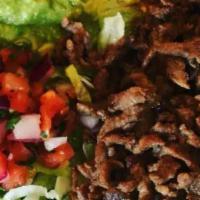9. Carne Asada Combo Plate · Carne asada (steak strips), served with rice, beans, lettuce, guacamole, pico de gallo and a...