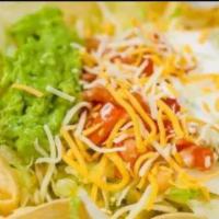 Chicken Taco Salad · Served with rice, lettuce, tomato, guacamole, sour cream, and cheese. Taco filling mixed wit...