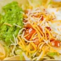 Carne Asada Taco Salad · Served with rice, lettuce, tomato, guacamole, sour cream, and cheese. Taco filling mixed wit...