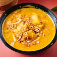 18. Yellow Curry · Creamy yellow curry with potatoes, white onions, carrots, & topped with fried onions. Served...