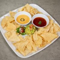 Trio Dip · Chips with salsa roja, guacamole and cheese.