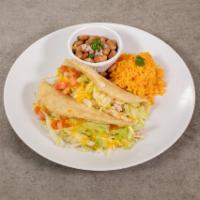 Puffy Tacos Plate · 2 puffy tacos (choice of meat), topped with tomatoes, lettuce and cheese.