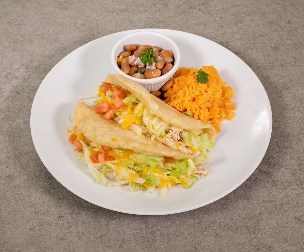 Puffy Tacos Plate · 2 puffy tacos (choice of meat), topped with tomatoes, lettuce and cheese.