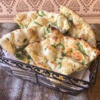 87. Garlic Naan · Soft white bread with fresh garlic and coriander baked in clay oven.