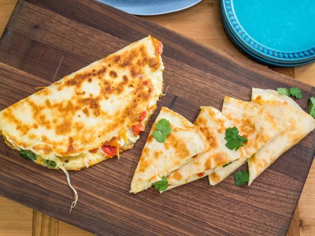 Quesadilla · Flour tortilla with melted cheese and green onion served with tomato, lettuce, guacamole and sour cream.