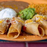 Chicken Taquitos · Deep fried corn tortillas filled with fresh chicken on a bed of lettuce and garnished with s...