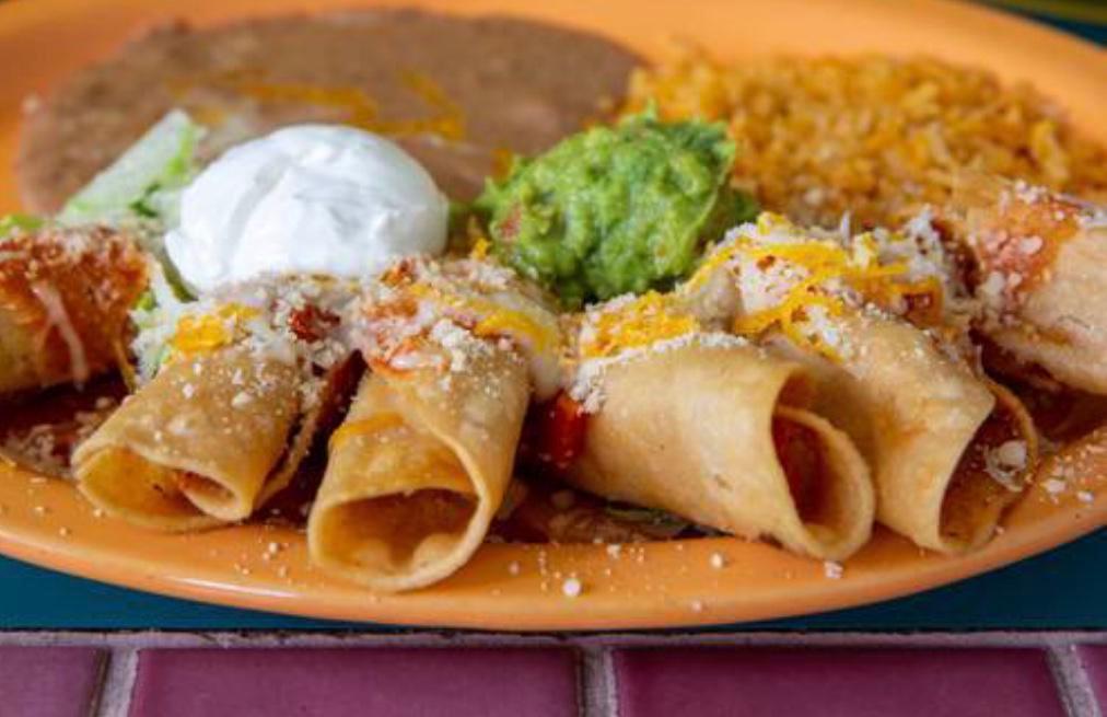 Beef Taquitos · Deep fried corn tortillas filled with fresh beef on a bed of lettuce and garnished with sour cream, parmesan cheese, guacamole, onions and tomatoes.