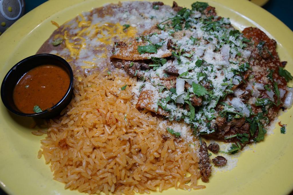 Tacos Rancheros · Charcoal broiled chopped steak tacos, garnished with onions, cilantro, salsa ranchera and Parmesan cheese. Served with rice and beans. 3  tacos.
