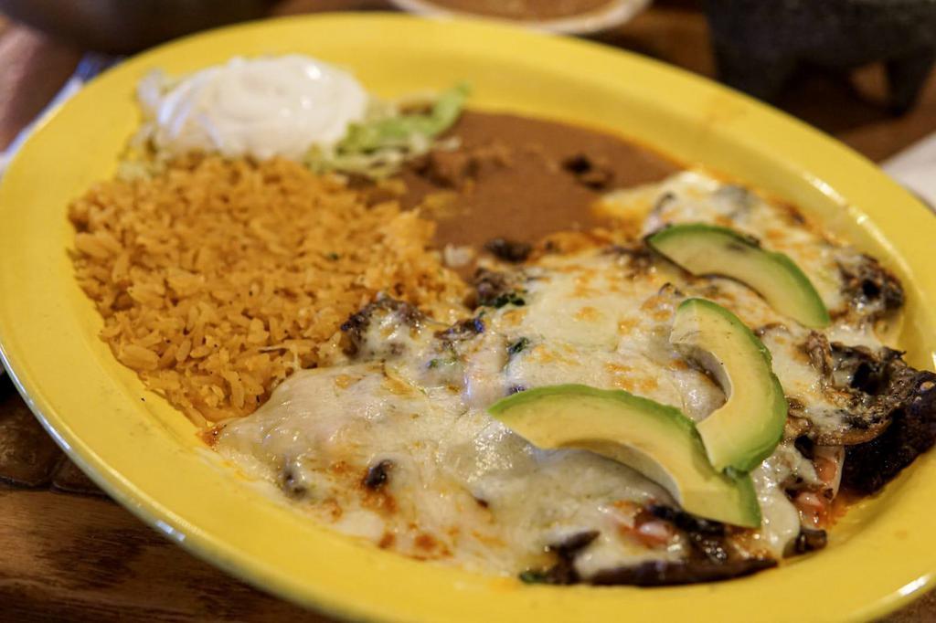 Steak City · Skirt steak with spicy sauce on top, melted Jack cheese, pico de gallo, mushrooms, slices of avocado and sour cream. Served with rice, beans, and tortillas.
