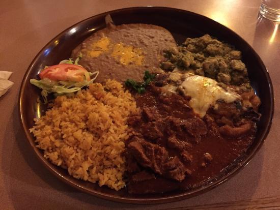 Tres Compadres · Chile verde chile colorado and 1 chile relleno with a side of pinto beans, rice and tortillas garnished with sour cream and lettuce.