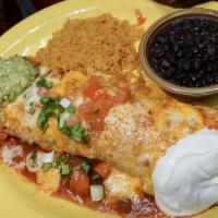 Macho Burrito · Soft flour tortilla filled with your choice of chicken or beef, rice and beans covered with ...