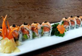 Slippery Salmon Roll · Spicy king crab mix, salmon, avocado, cucumber, topped with spicy salmon, masago and toasted...