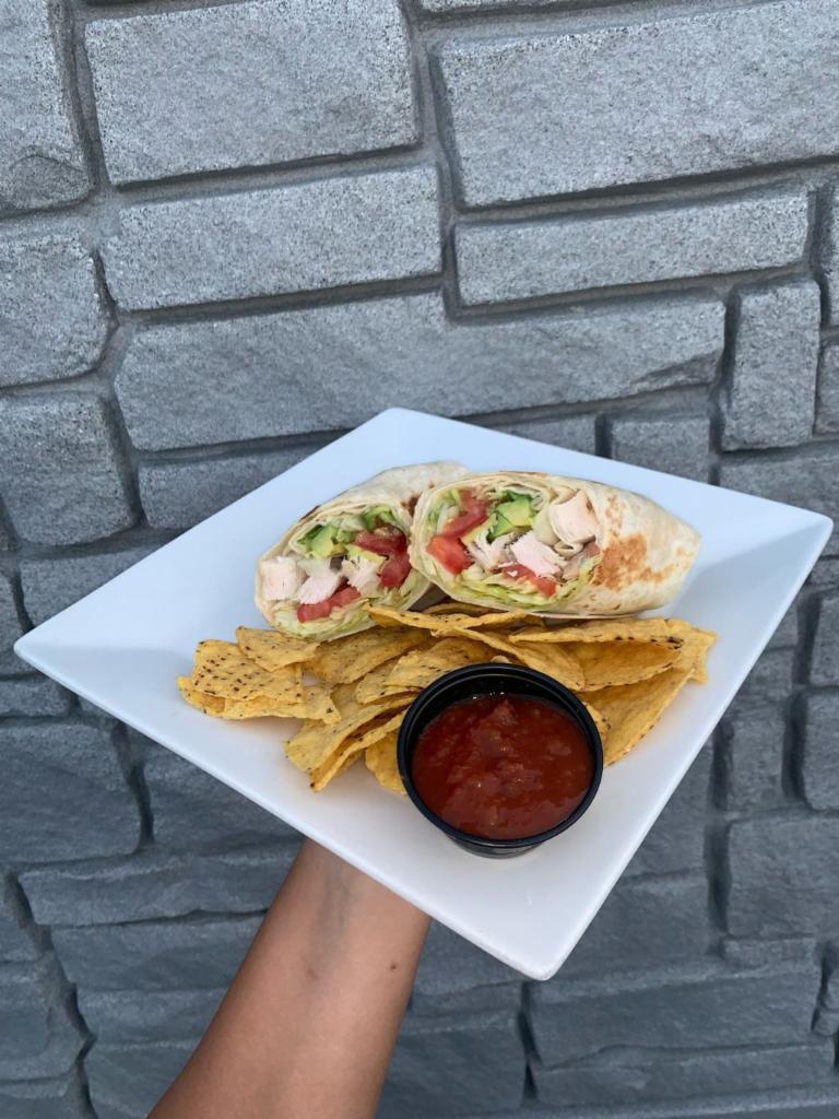 Chef Josue's Chicken Wrap · Another Chef Josue original.  His signature chicken with lettuce, tomato, and mayo;  all wrapped in a tortilla.  Comes served with pita chips.