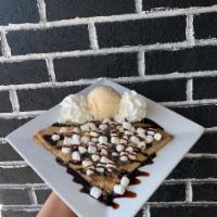 S'mores Crêpe · A campfire-inspired crepe covered in chocolate chips, graham cracker crumbs, mini marshmallo...
