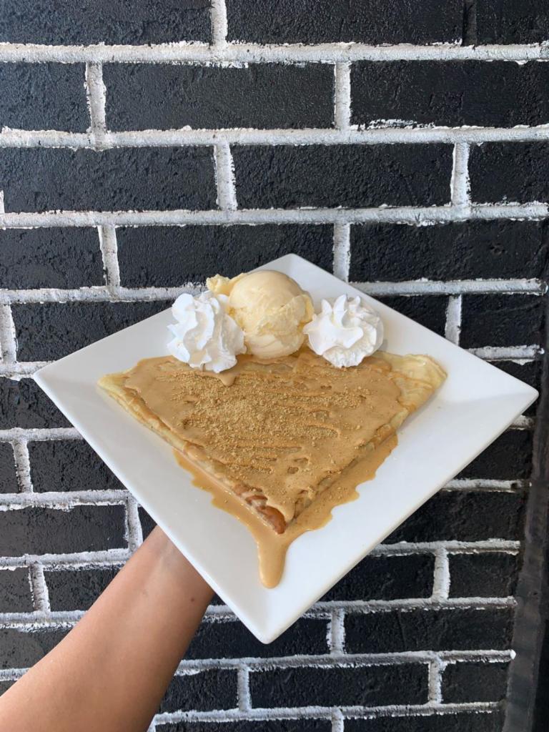 Dulce de Leche Cream Cheese Crêpe · Our homemade crepe is covered in a caramelly & creamy blend of dulce de leche and cream cheese.  Comes topped with whipped cream and one scoop of either vanilla, chocolate, or strawberry ice cream!