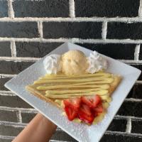 Mango Crème & Strawberry Crêpe · A tasty tropical treat that comes with our mango crème and slices of fresh strawberries.  Co...