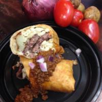 Garbage Burrito · Cheeseburger, macaroni salad and smashed potatoes rolled together, then fried and topped wit...