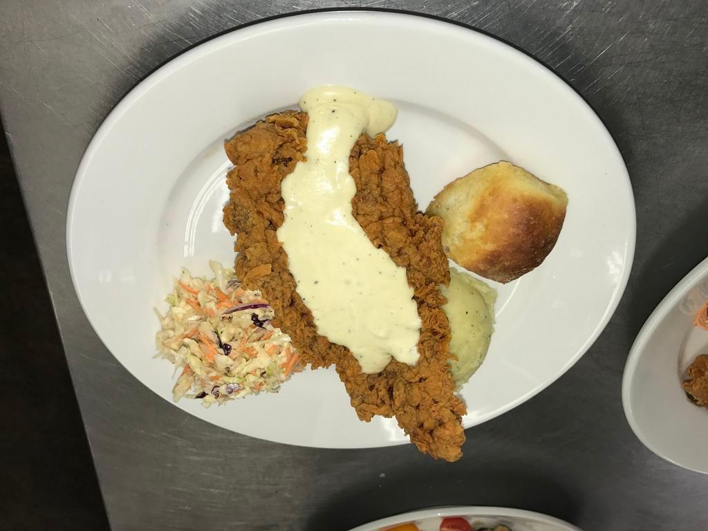 Chicken Fried Steak · Topped with milk gravy or spicy gravy, served with mashed potatoes and cole slaw.