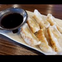 Gyoza (pork) · 6 pieces pork gyoza. Pan-fried dumplings served with soy vinegar dipping sauce.