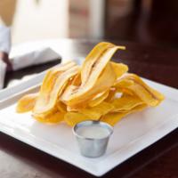 Mariquitas  · Homemade plantain chips with garlic sauce.