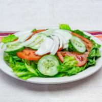 Garden Salad · Iceberg lettuce, tomato onion, cucumber, black olives choice of dressing.
