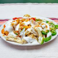 Chicken Over Rice · Peppers and onions, red hot sauce and white sauce.
