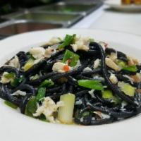 Spaghetti al Granchio · Homemade black Spaghetti with wild blue crab meat, scallion, lemon, and calabrian chili.