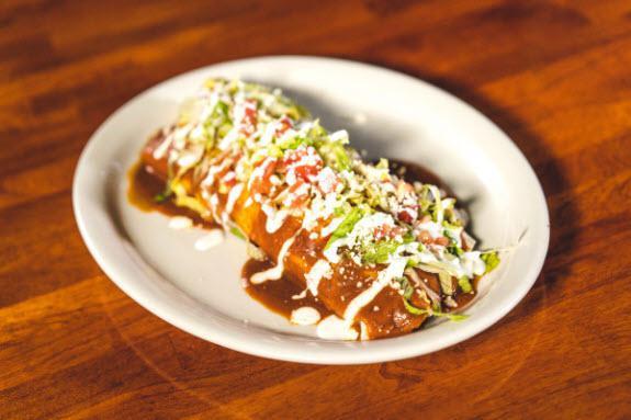Burrito Supremo  · Filled with your choice of meat, Spanish rice, refried beans, lettuce, tomatoes, queso fresco, sour cream and topped with special sauce.