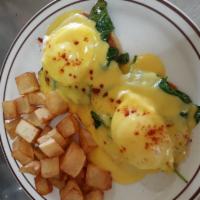 Eggs Florentine · 2 poached eggs and sauteed spinach atop a grilled English muffin topped with hollandaise sau...