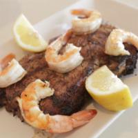 Omonia's Surf and Turf · Chargrilled ribeye steak and grilled shrimp served with crispy roasted potatoes and asparagu...