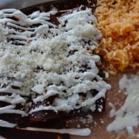 Enchilada Poblanas ·  Three tortillas filled with chicken And covered in our signature Mexican mole sauce and top...