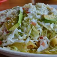 Enchilada Verde · Three tortillas filled with chicken, covered with our green salsa, queso fresco, onion, sour...