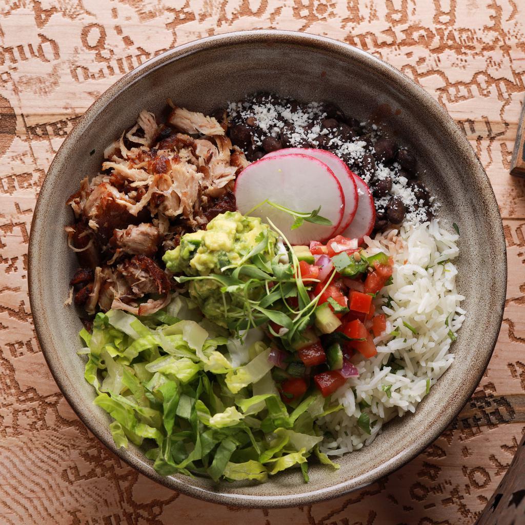 Pork Carnitas Bowl · Mesquite grilled and confit pork shoulder, romaine, black beans, cilantro lime rice, roasted corn, and side of cilantro lime vinaigrette