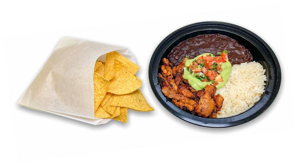 PASTOR BOWL · Pastor Adobo pork served in a delicious bowl with vegan lime rice and vegan black beans,  topped with avocado salsa, pico de gallo, and cilantro. Includes a bag of tortilla chips.