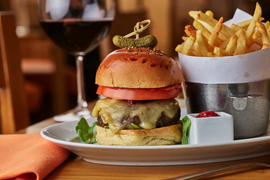 THE FRENCHIE BURGER · certified angus beef, confit pork belly, tomato compote, raclette cheese, served with pomme frites
