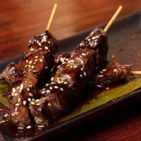 Skewers · Three skewers of seared fliet mignon or chicken cooked in sake teriyaki sauce; topped with s...