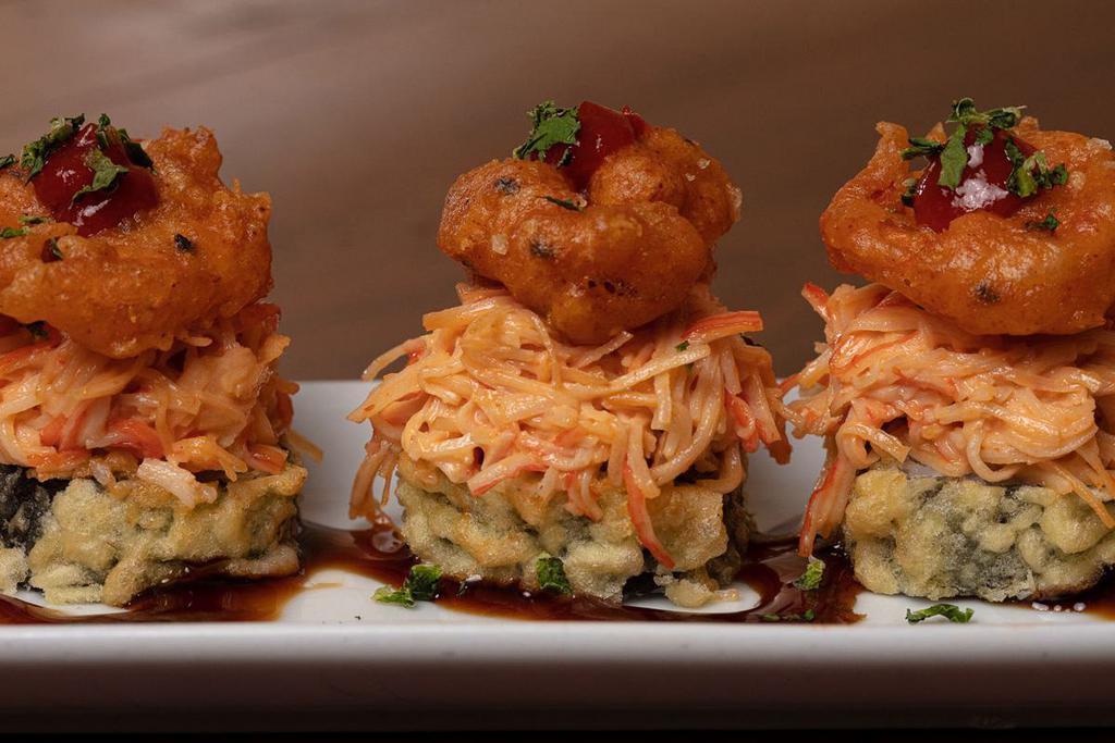 Chili Shrimp Roll · Krab† and cream cheese rolled and lightly tempura battered, topped with spicy krab† mix, crispy shrimp and cilantro; served with Sriracha and sweet eel sauce
