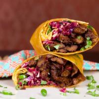 Spicy Beef Wrap · Beef less beef strips tossed in a spicy and tangy sauce, fresh sesame ginger slaw, serrano p...