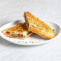 Breaded Eggplant Panini · Served with pesto, roasted peppers and mozzarella.