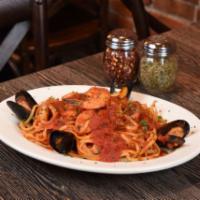 Seafood Combo (Shrimp, Mussels, Clams, Calamari) · Served over pasta with marinara sauce.