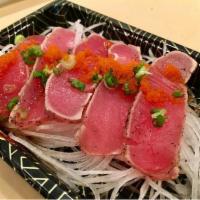 M1. Pepper Tuna Tataki · 5 pcs. Seared black tuna, tobiko, scallion and daikon radish with yuzu sauce.