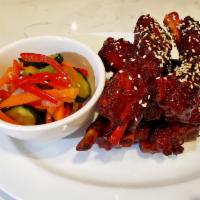 BBQ Baby Ribs (5pc) · Slow braised, wok-seared pork ribs served with a homemade barbecue sauce and Asian coleslaw