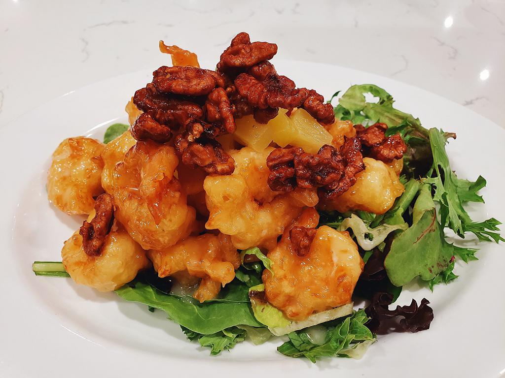 Pineapple Walnut Shrimp · Crispy battered shrimp tossed coconut mayo sauce, over a bed of romaine lettuce, topped with walnuts and pineapples. 
