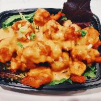 Dynamite Shrimp · Lightly breaded tempura shrimp on a bed of organic spring mix topped with sriracha mayo sauce.