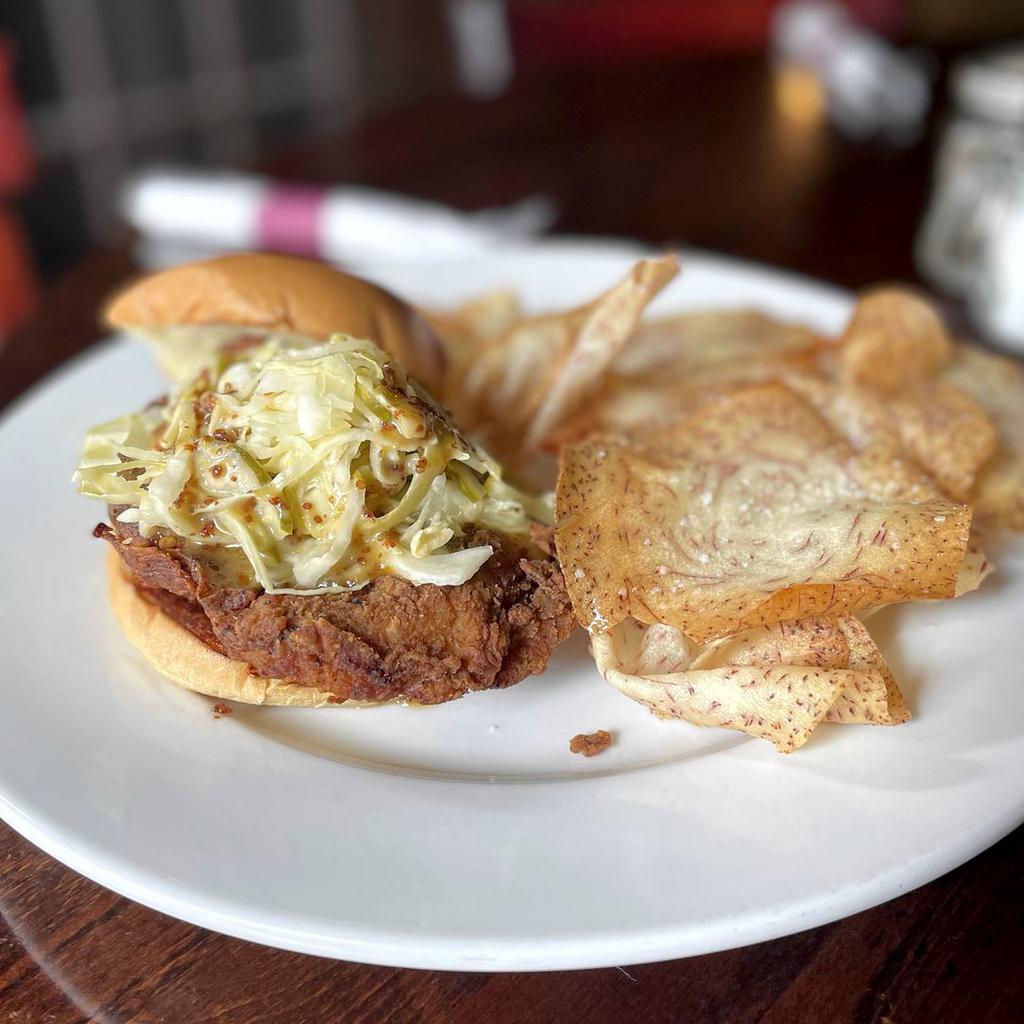 Crispy Honey Mustard Chicken Sandwich · Deep fried crispy chicken breast, smoked honey mustard, pickled slaw, brioche bun and a side of fries.
