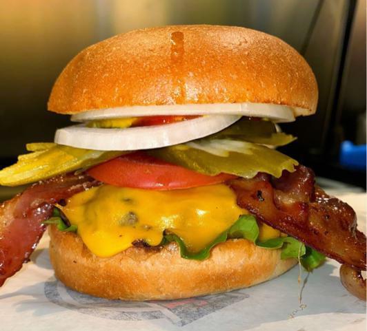 Undercover Cheeseburger · Beef patty, hickory smoked bacon, cheddar cheese, lettuce, tomatoes, onions, pickles, mustard and ketchup.