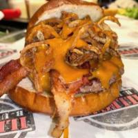 Slinger · Beef patty, hickory smoked bacon, cheddar cheese, fried onion strings,  House BBQ sauce.
