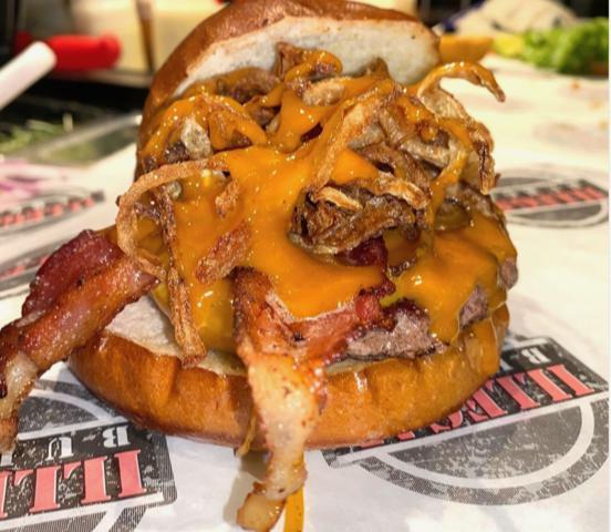 Slinger · Beef patty, hickory smoked bacon, cheddar cheese, fried onion strings,  House BBQ sauce.