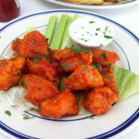 Boneless Buffalo Wings · Served with blue cheese dressing and celery sticks.